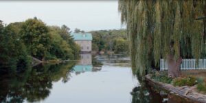 View downriver shows an historic building in the distance in Hastings, Ontario