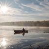 Silhouette of solo canoeist on a lake