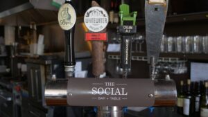 Selection of beer taps, branded with The Social: Bar + Table