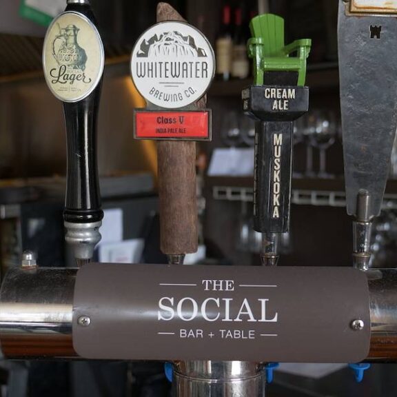 Selection of beer taps, branded with The Social: Bar + Table