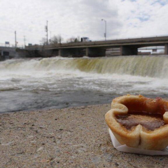 A butter tart on a wall beside Fenelon Falls
