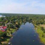 Aerial view of rural community, with stretch of water front and centre