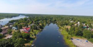 Aerial view of rural community, with stretch of water front and centre