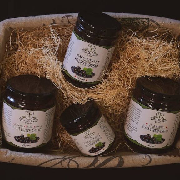A basket containing black currant products from Popham Lane Farm