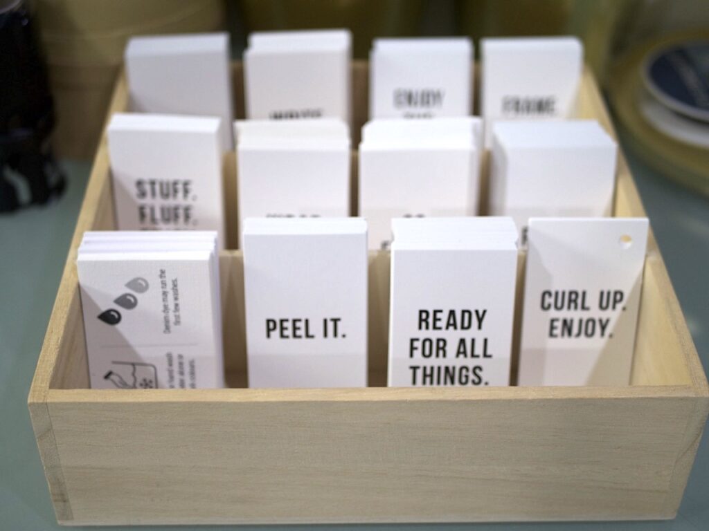 A box full of cards printed with a wide variety of slogans