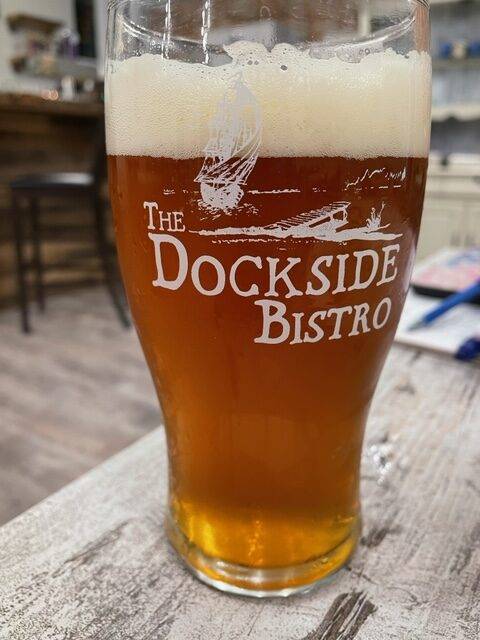 A pint of beer in a "The Dockside Bistro" branded glass