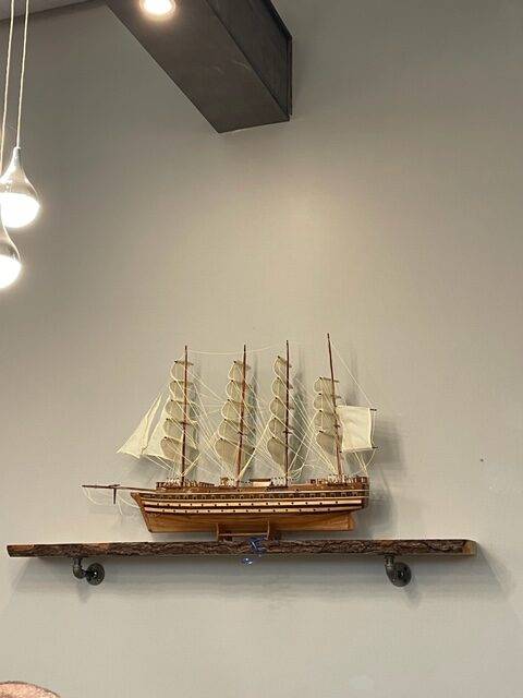 A model wooden ship on a shelf