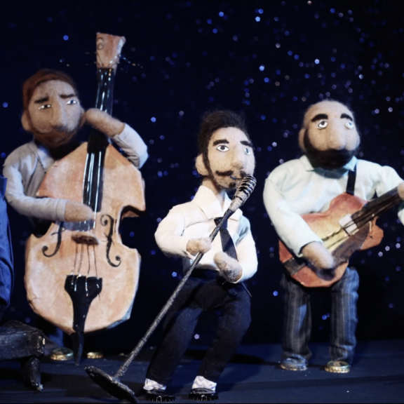 Four felt puppets play in a jazz quartet, in a still from a Cardboard Reality video