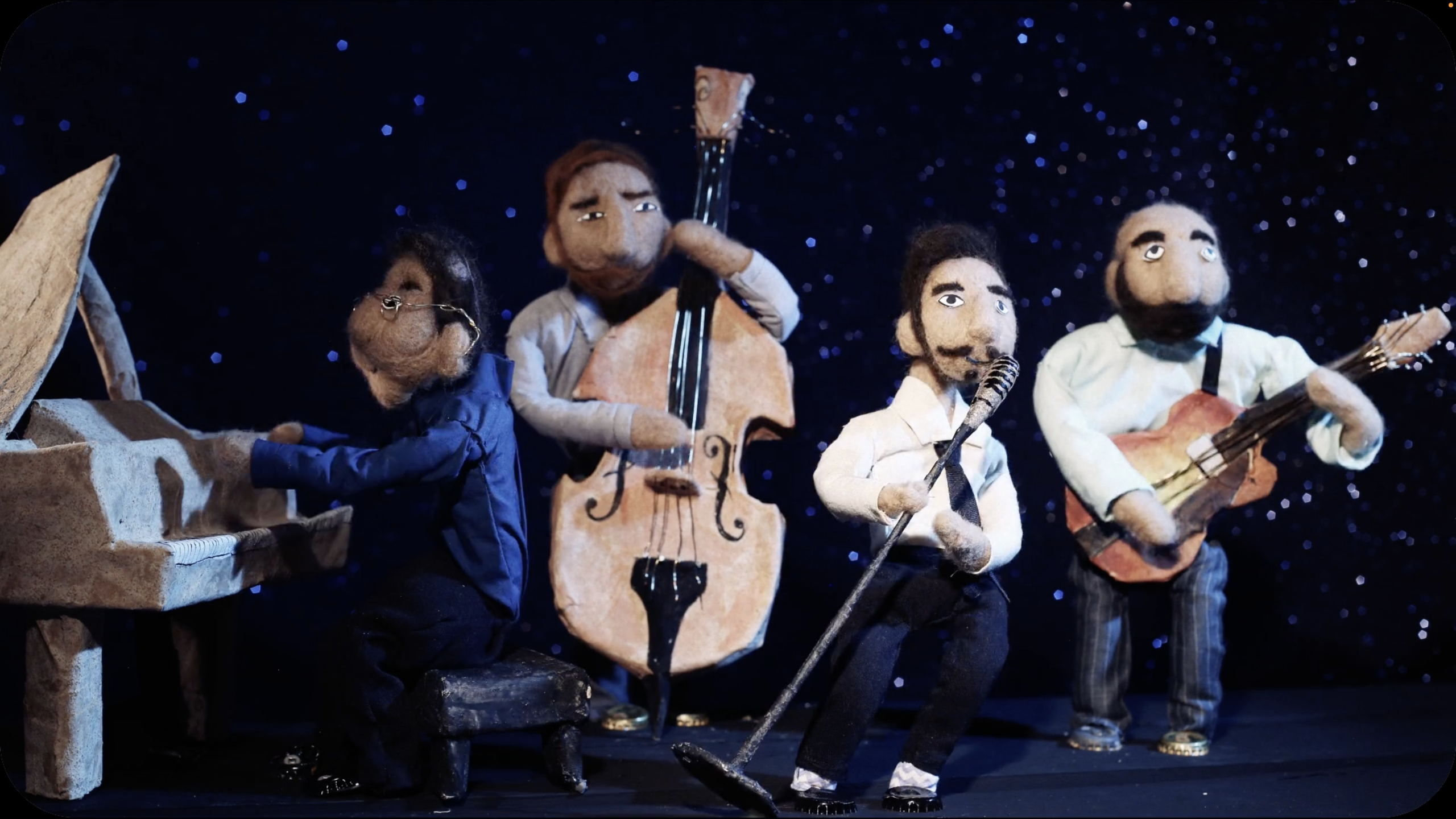 Four felt puppets play in a jazz quartet, in a still from a Cardboard Reality video