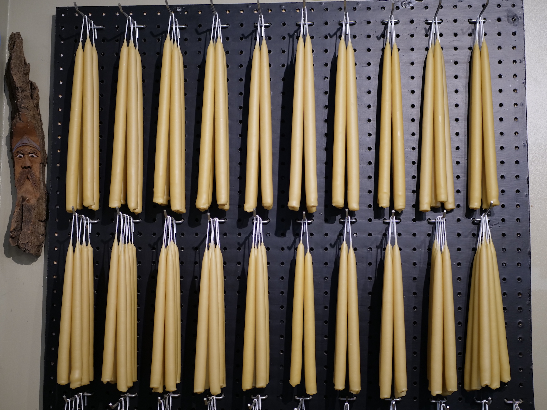 A wall of beeswax candles