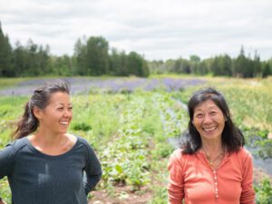 Tessa and Kumiko Uchikura pose for a portrait on their farm