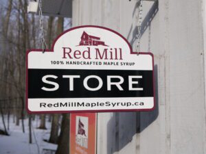 Sign reading STORE outside Red Mill Maple Syrup building