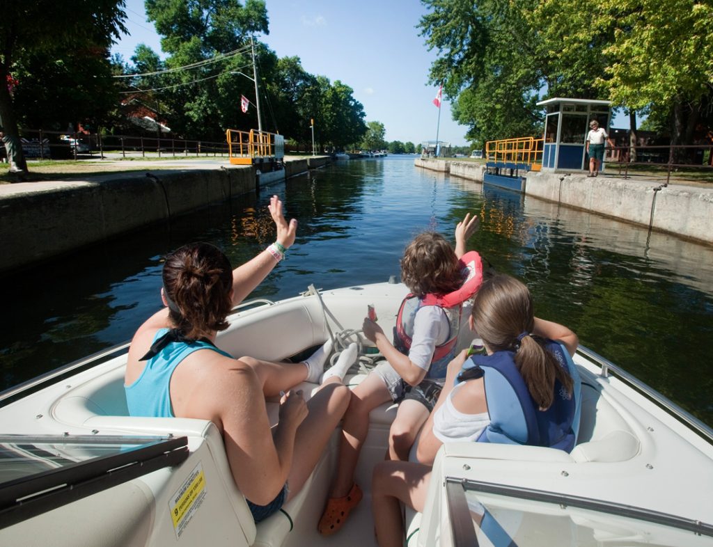 People in a boat in a concrete wave to people onshore