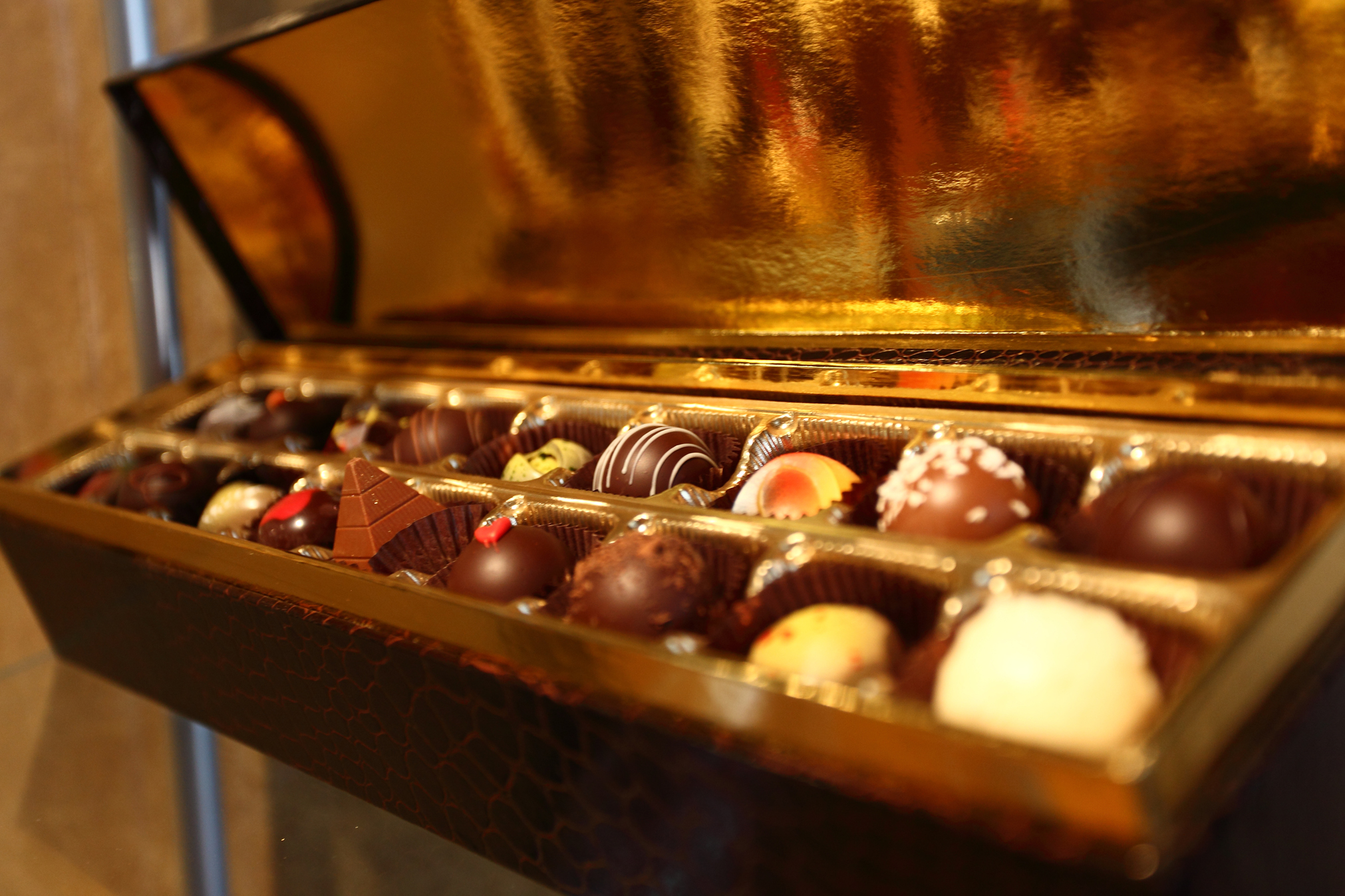 Two rows of fancy chocolates in a shiny box