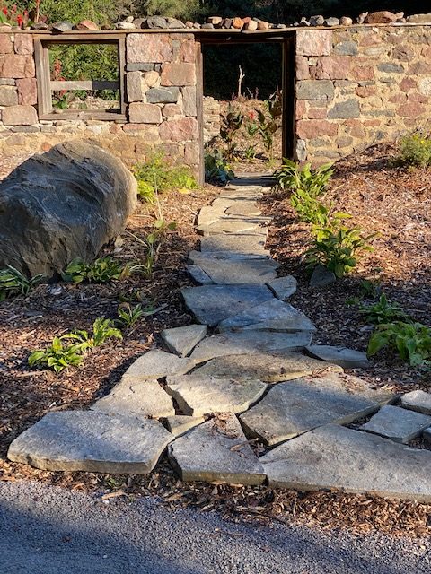 A stone pathway leading into the Ennismore Secret Garden