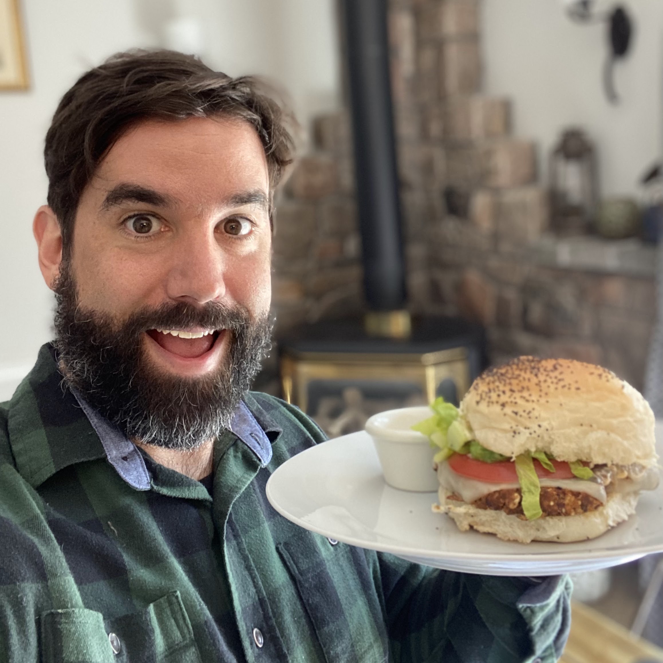 Jeff Bray holds a burger up to the camera