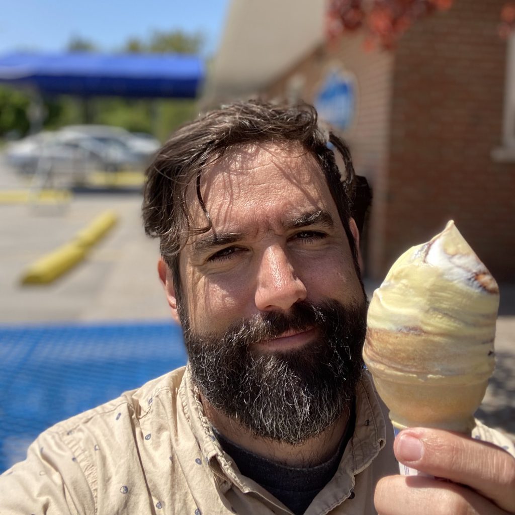 Jeff Bray holds an ice cream cone towards the camera