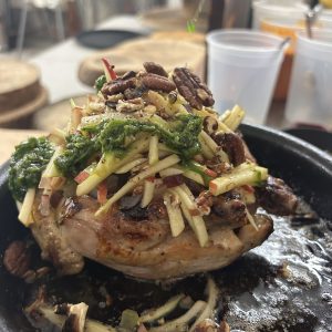 A Cornish hen piled with vegetables and nuts