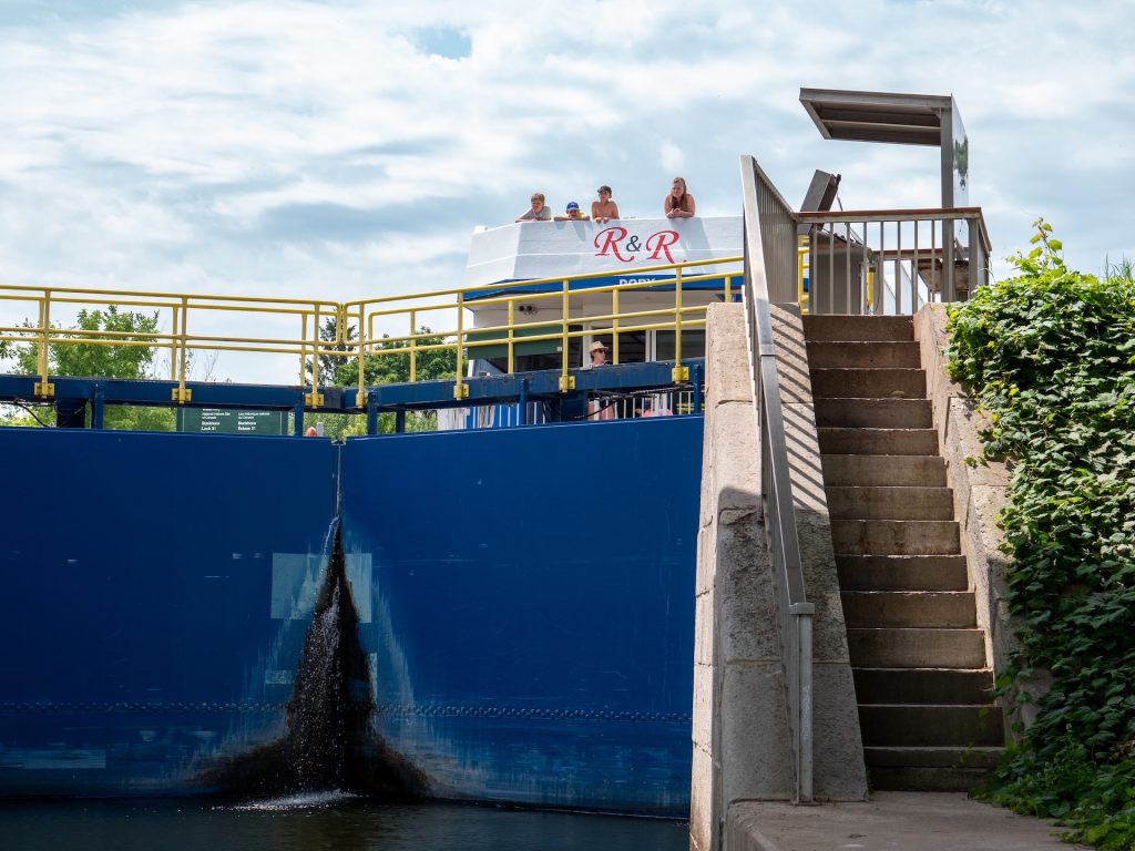 The blue gates of lock, with a houseboat waiting at the top