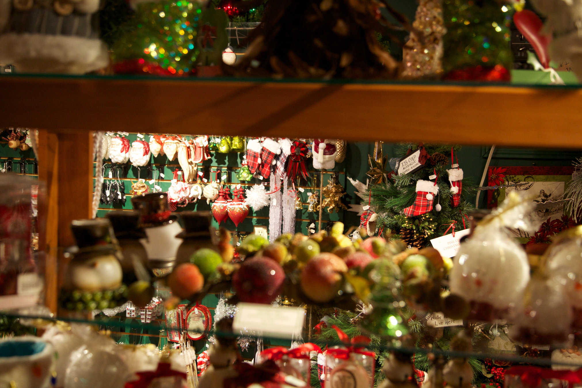 A collection of richly coloured Christmas ornaments in a shop window