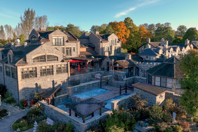 Elevated view of spa, showing pools and fieldstone buildings